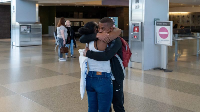 CWS-client-Vanessa-greets-her-brother-CWS-client-Luis-at-RDU-3-scaled