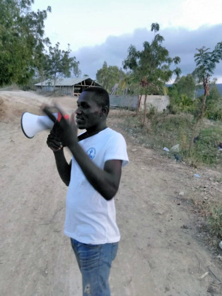 A GRADAID team member uses a megaphone to share information about COVID-19 in Northwest Haiti. Photo courtesy GRADAID.