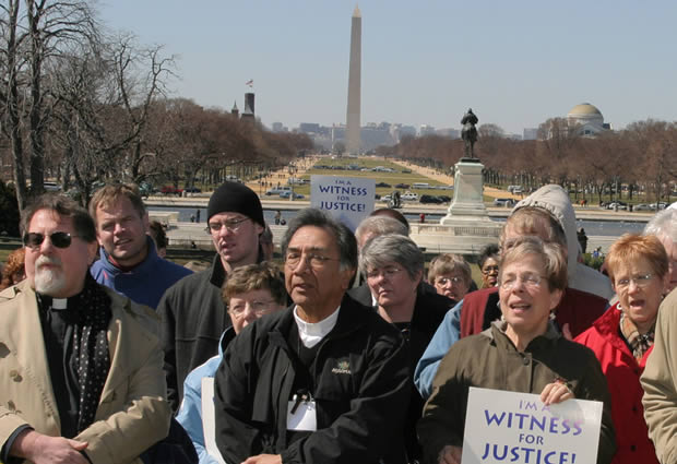Photo of Advocates with signs that say "witness for justice".